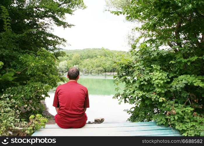 Men relaxing on lake