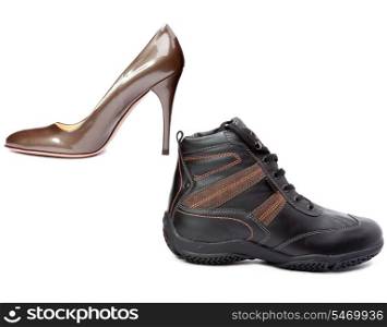 Men&rsquo;s boots and elegant female shoes on white background