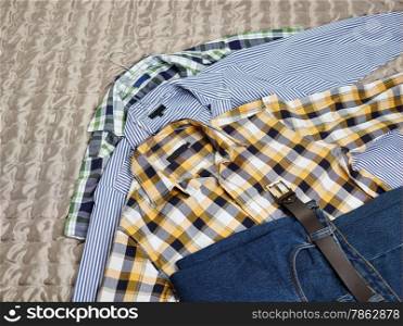 Men&rsquo;s casual patterned shirts and jeans on the bed