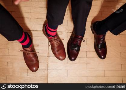 Men's feet in stylish shoes and funny socks. male style. Men's feet in stylish shoes and funny socks. male style.
