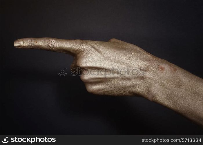 men&rsquo;s hands indicate in the gold make-up