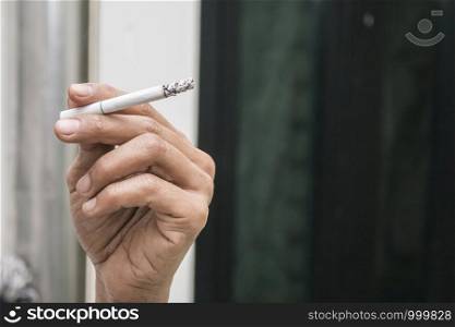 Men's hands with a cigarette close-up