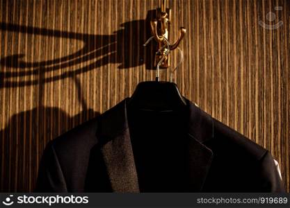 Men's jackets on hangers in a men's clothing store. Men's jacket on a rack. Men's jackets on hangers in a men's clothing store. Men's jacket on a rack.
