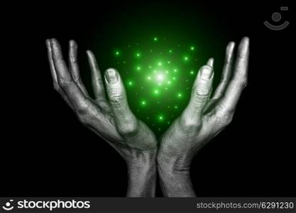 Men&rsquo;s silver hand with magical energy on a black background