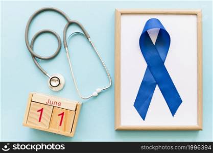 men s health week awareness blue ribbon wooden white frame stethoscope
