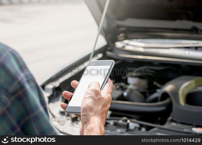 Men?s right hand is using a smartphone to contact. The vehicle is experiencing problems or accidents, mockup phone concept.