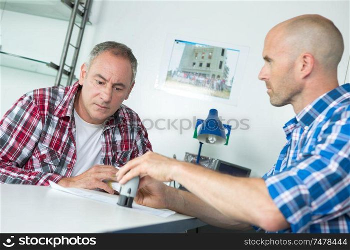 men signing a contract at office