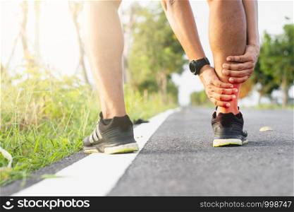 Men sit and run, are experiencing ankle pain while exercising.