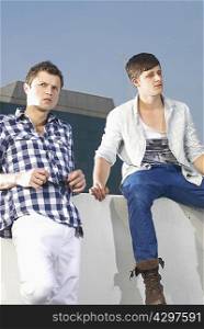 Men sitting on wall outdoors