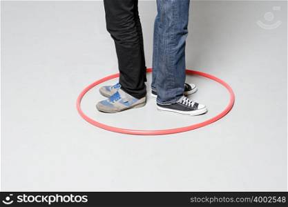 Men standing in plastic hoop