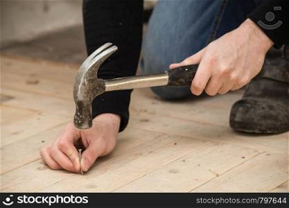 Men Using a hammer and nail on wood , renovation concept building new home. Men Using a hammer and nail on wood , renovation concept