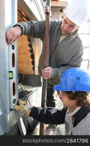 Men using a spirit level on a window