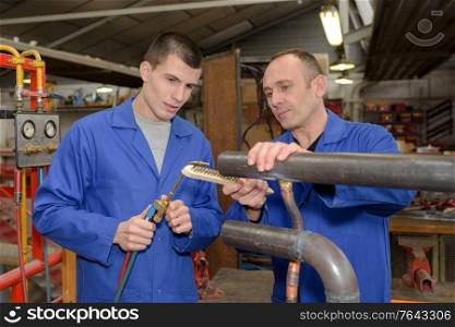 men using industrial gas fed machine