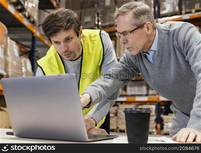 men warehouse working laptop