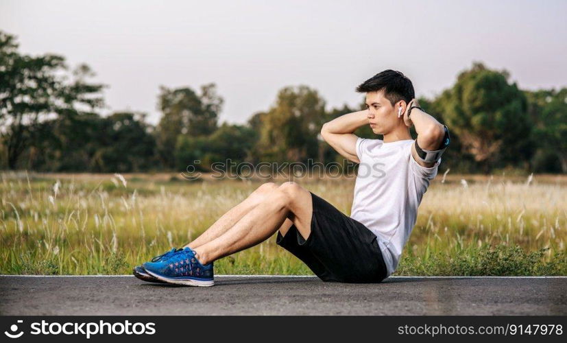 Men warm up before and after exercising. Selective focus.