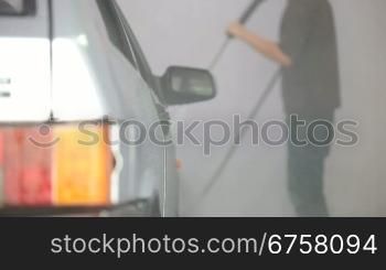 men wash car with water pressure machine