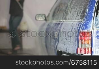 men wash car with water pressure machine