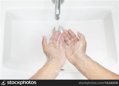 Men wash their hands and protect them from the virus, Covid 19 and bacteria.