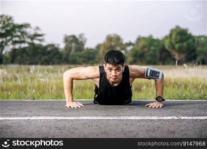 Men wear black shirts with muscles push up on the street.