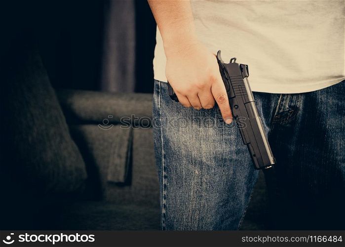 Men wearing t-shirts, jeans Standing holding a gun in the house