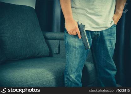 Men wearing t-shirts, jeans Standing holding a gun in the house