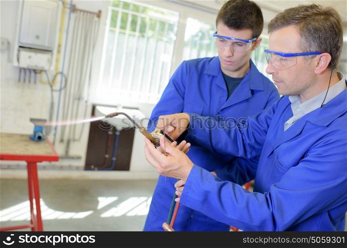 men with blowtorch