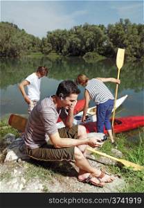 men with canoe in nature