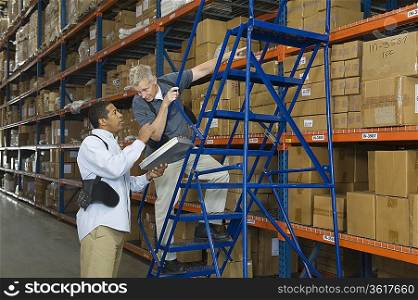 Men working in distribution warehouse