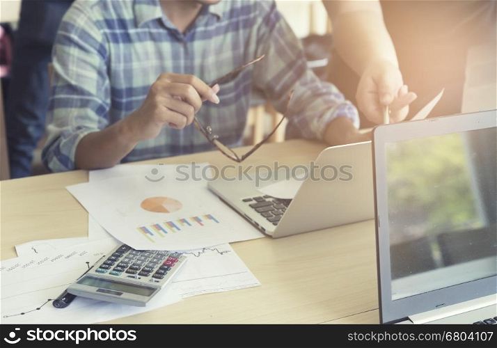 men working with calculator, business document and laptop computer notebook, vintage tone