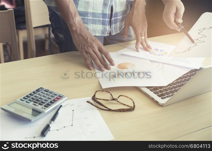 men working with calculator, business document and laptop computer notebook, vintage tone