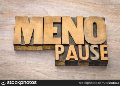 menopause word abstract in vintage wood letterpress printing blocks against grained wood