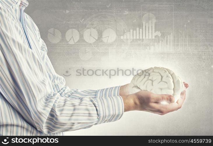 Mental health. Close up of human hand holding brain