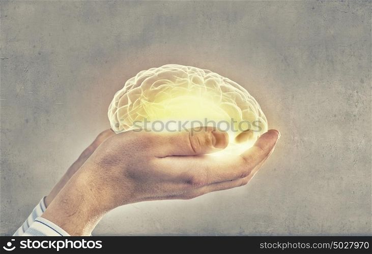 Mental health. Close up of human hand holding brain