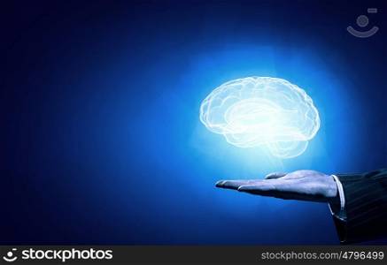 Mental health. Close up of human hand holding brain on blue background