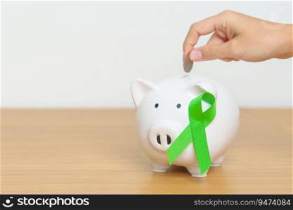 Mental Health, Liver, Gallbladders, bile duct, Cancer and Lymphoma Awareness month, green Ribbon with Piggy Bank for support illness life. Donation, Charity, C&aign, Money Saving, Fund 