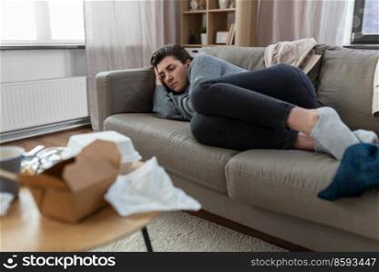 mental health, psychological problem and depression concept - stressed woman lying on sofa at home. depressed woman lying on sofa at home