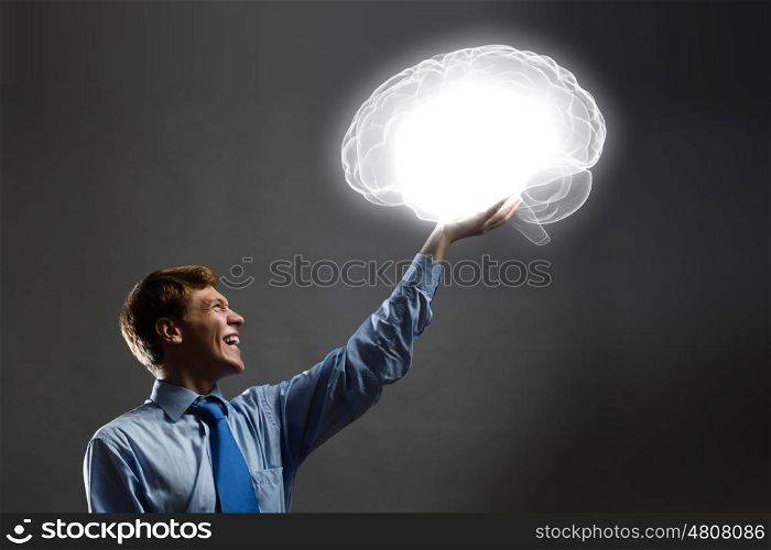 Mental health. Young man holding 3d image of human brain in hand