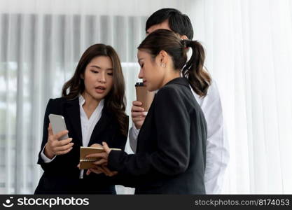 Mentor, manager with coffee advice younger colleagues in workplace. Businesspeople discussing or planning financial project strategy, talking together for harmony and strong teamwork in office concept. Manager with coffee advice colleagues as concept of harmony in office.