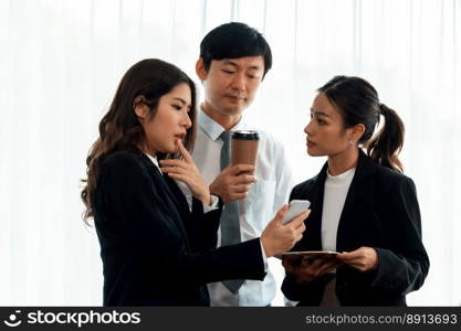 Mentor, manager with coffee advice younger colleagues in workplace. Businesspeople discussing or planning financial project strategy, talking together for harmony and strong teamwork in office concept. Manager with coffee advice colleagues as concept of harmony in office.