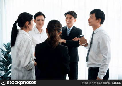 Mentor, manager with coffee advice younger colleagues in workplace. Businesspeople discussing or planning financial project strategy, talking together for harmony and strong teamwork in office concept. Manager with coffee advice colleagues as concept of harmony in office.