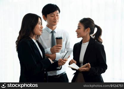 Mentor, manager with coffee advice younger colleagues in workplace. Businesspeople discussing or planning financial project strategy, talking together for harmony and strong teamwork in office concept. Manager with coffee advice colleagues as concept of harmony in office.