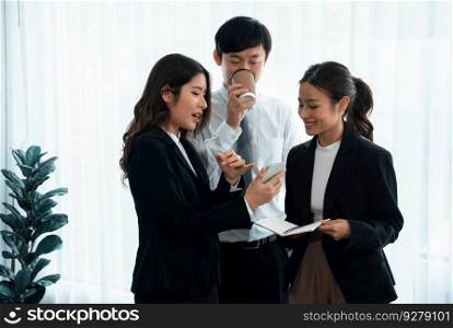 Mentor, manager with coffee advice younger colleagues in workplace. Businesspeople discussing or planning financial project strategy, talking together for harmony and strong teamwork in office concept. Manager with coffee advice colleagues as concept of harmony in office.