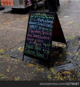 Menu sandwich board on sidewalk in Manhattan, New York City, U.S.A.