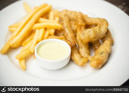 menu with fried shrimp and french fries with sauce on a plate