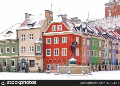 Merchants houses and fountain at Old Market Square in Old Town in the snowy winter day, Poznan, Poland. Snowy Old Town of Poznan, Poland
