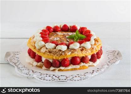 Meringue cake with strawberry yogurt on white wood.. Meringue cake with strawberry yogurt on white wood
