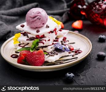 meringue slices and blueberry ice cream ball with berries
