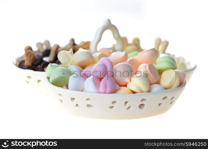 meringues and other cookies in porcelain bowl