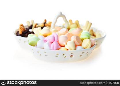 meringues and other cookies in porcelain bowl