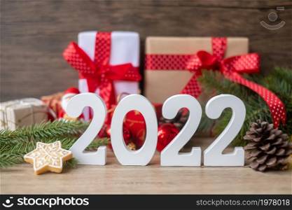 Merry Christmas and 2022 Happy New Year with decoration on table. Xmas eve, party, holiday and boxing day concept
